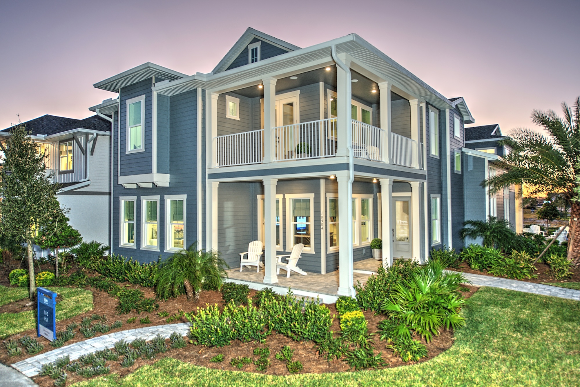 Image of ICI Homes Maui Model in Laureate Park in Lake Nona, Orlando Florida. Blue house with white trim and large porch on first and second floor.